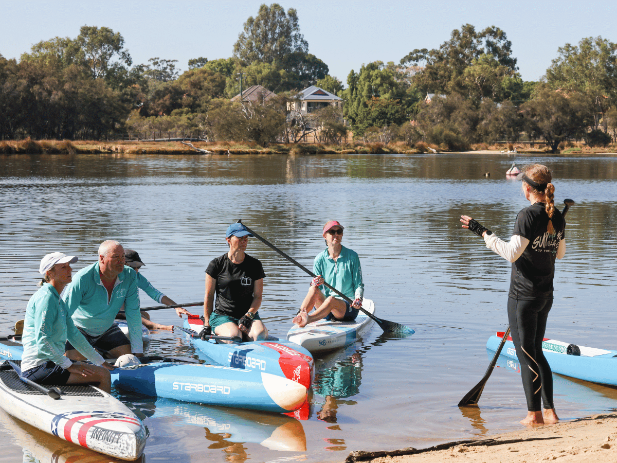 Maree instructing a SUP class on skills and drills for stand-up paddle boarding