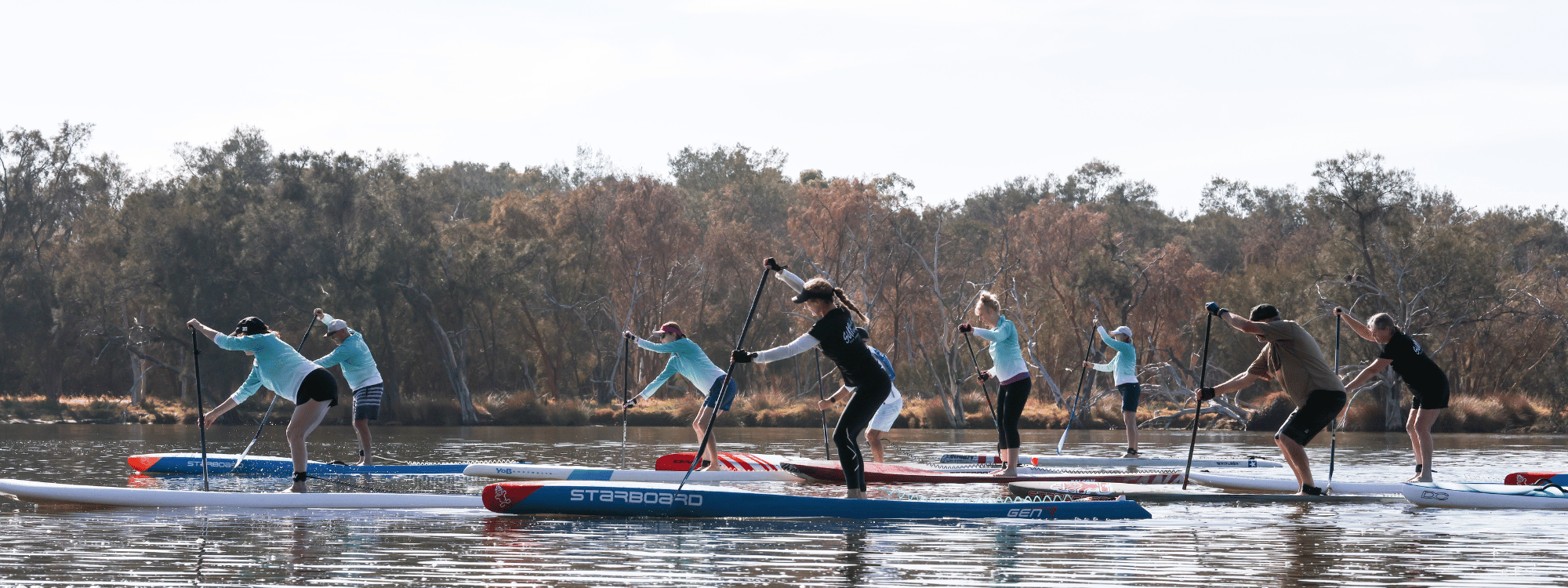 a picture of Maree, Suptonic's founder instructing a class of standup paddle boarders